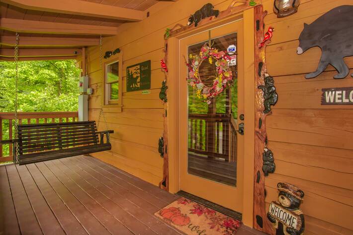 Front porch, front door, wooden porch swing,