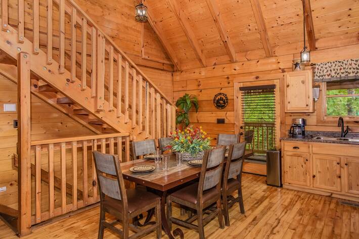 View of dinning room, view of stairs leading upstairs and downstairs, large dinning room table able to seat six people