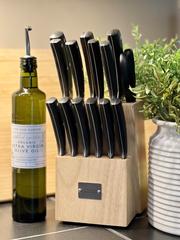 Bottle of extra virgin olive oil, knife block and cutting board