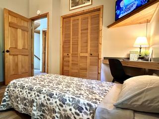 View of folding bed in bedroom nearest the bathroom.  
