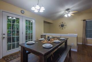 Farmhouse dining table with two benches and stairway to lower level