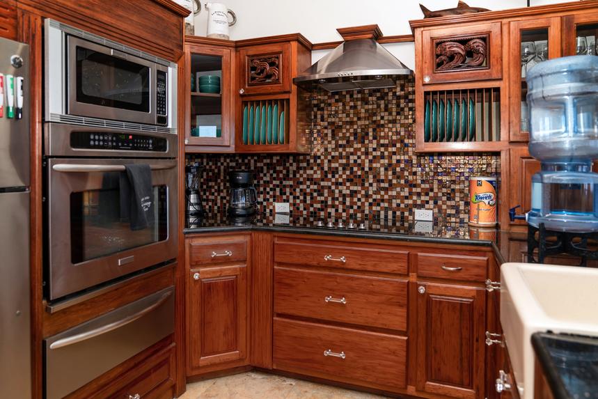 Fully equipped kitchen with modern appliances, spacious counters, and a functional layout for cooking and dining.