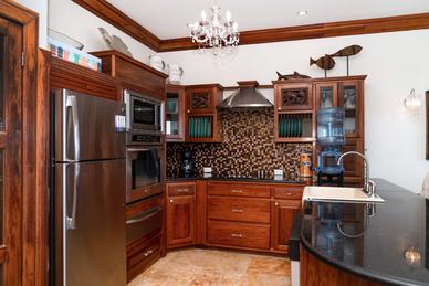 Fully equipped kitchen with modern appliances, spacious counters, and a functional layout for cooking and dining.