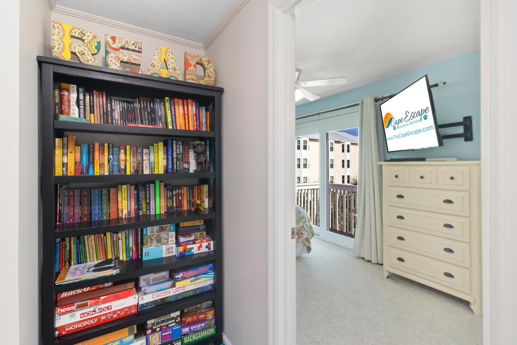 Well-stocked bookshelf with entertainment and games galore!