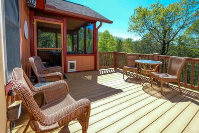 Sunset View Chalet open side deck with wicker furniture