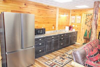 Creekside Lodge lower level multipurpose room with kitchenette with full size refrigerator