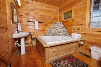 Pigeon Forge Possum Moon Cabin waterfall spa jacuzzi tub in master suite