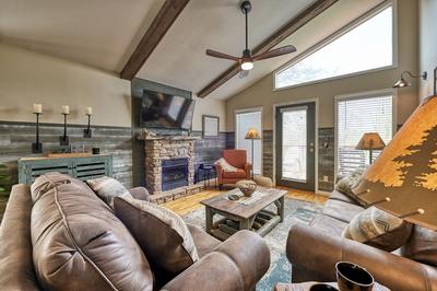 The Playful Bear living room with stone encased gas fireplace