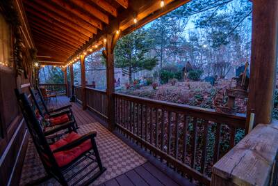 Mountain Magic covered entry deck with rocking chairs