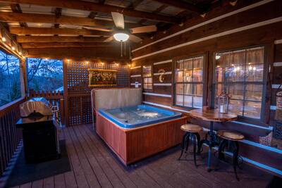 Mountain Magic main level covered back deck with hot tub
