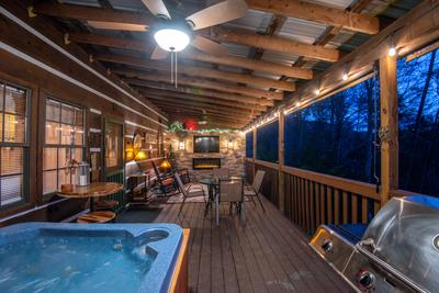 Mountain Magic main level covered back deck with hot tub