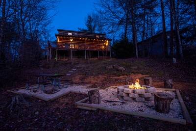 Mountain Magic outdoor fire pit and cabin at night