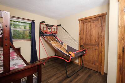 Moose Haven Cabin - Bedroom 2 with twin over full bunk bed and arcade basketball machine
