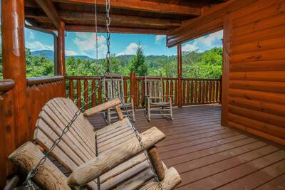 Katies Lodge main level covered back deck with swing and rocking chairs