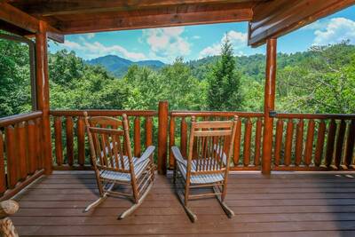 Katies Lodge main level covered back deck with rocking chairs