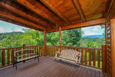 Katies Lodge main level covered back deck with swing and rocking chairs