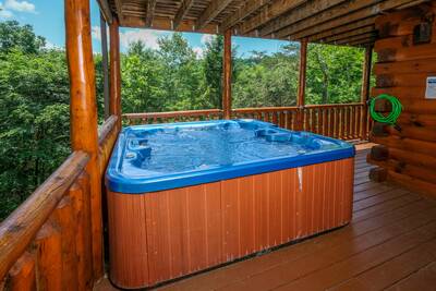 Katies Lodge main level covered back deck with hot tub