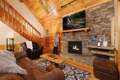 Treeside living room with 60-inch flat screen TV