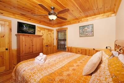 Treeside main level bedroom 1 with 32-inch flat screen TV