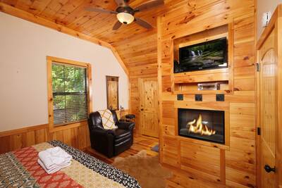 Treeside upper level bedroom 2 with year-round electric fireplace