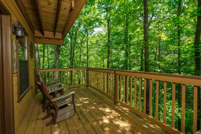 Treeside main level back deck with rocking chairs