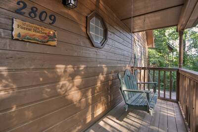 Forest Hollow covered front deck with swing