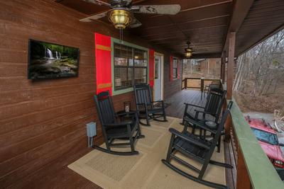 Margaritas at Sunrise - Covered front deck with rocking chairs and 32-inch TV