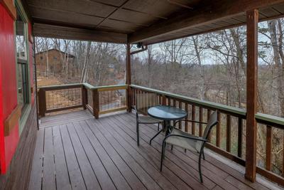 Margaritas at Sunrise - Covered front deck with metal table and chairs