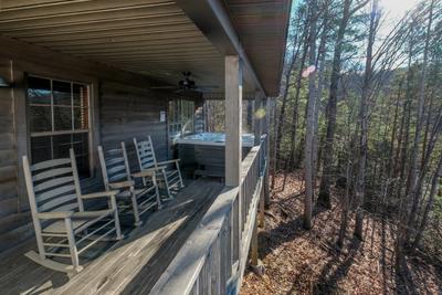 The Hidden End covered back deck with rocking chairs