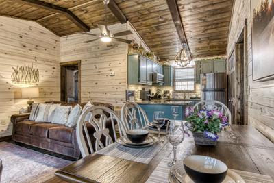 Water's View dining table, living room, and kitchen