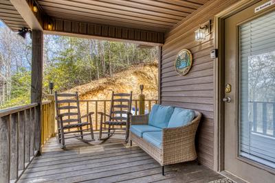 Water's Edge covered entry deck with rocking chairs