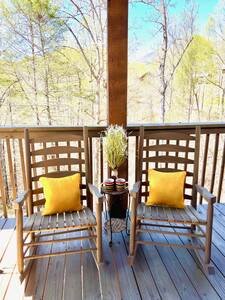 A Mountain Hideaway Lodge - Covered entry deck with rocking chairs