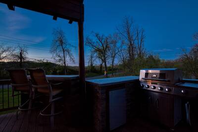 River Livin - Outdoor kitchen at night with glowing countertops