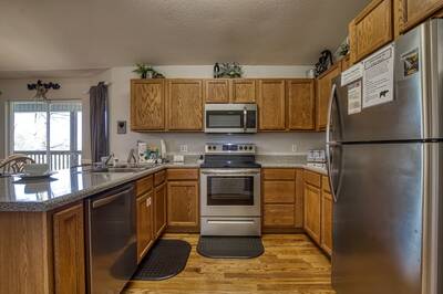 Inn The Vicinity - Fully furnished kitchen with stainless steel appliances