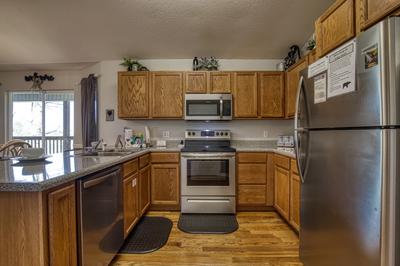 Inn The Vicinity - Fully furnished kitchen with stainless steel appliances