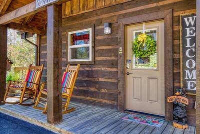 A Mountain Hideaway Lodge - Covered entry deck with rocking chairs