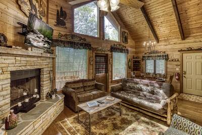 Cedar Lodge - Living room with stone encased gas fireplace
