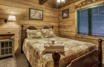 Cedar Lodge - Main level bedroom one with a queen size bed