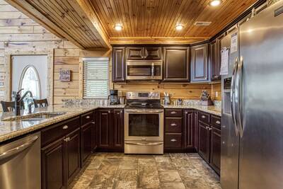 Angels View - Fully furnished kitchen with granite countertops and stainless steel appliances