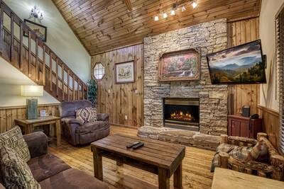 Mountain Side - Living room with stone encased gas fireplace