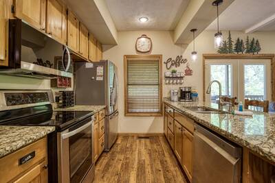 Best Time Ever fully furnished kitchen with stainless steel appliances