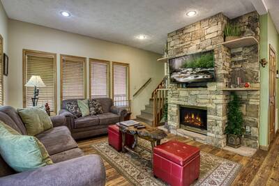 Best Time Ever living room with stone encased gas fireplace