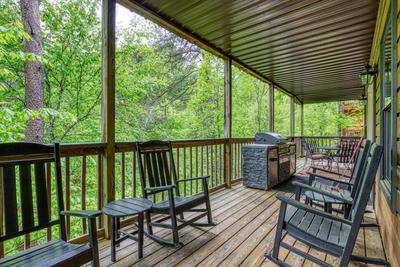 Best Time Ever covered back deck with rocking chairs