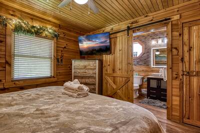 My Pigeon Forge Cabin - Main level bedroom 1 with 50-inch TV