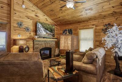 Cabin Fever living room with stone encased gas fireplace