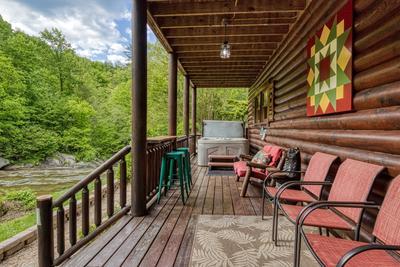 Creekside Lodge - Covered wrap around deck with a hot tub