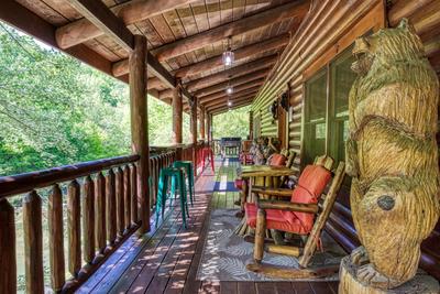 Creekside Lodge - Covered wrap around deck with rocking chairs