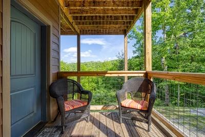 Wild Heart Lodge - Covered lower deck with wicker chairs