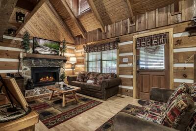Cozy Bear Escape living room with stone encased gas fireplace