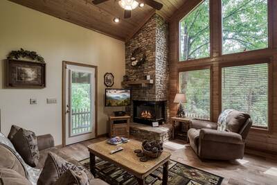 Reflections - Living room with stone encased gas fireplace